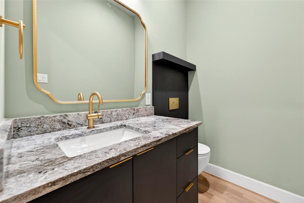 Downstairs powder bath with wall mounted comode.
