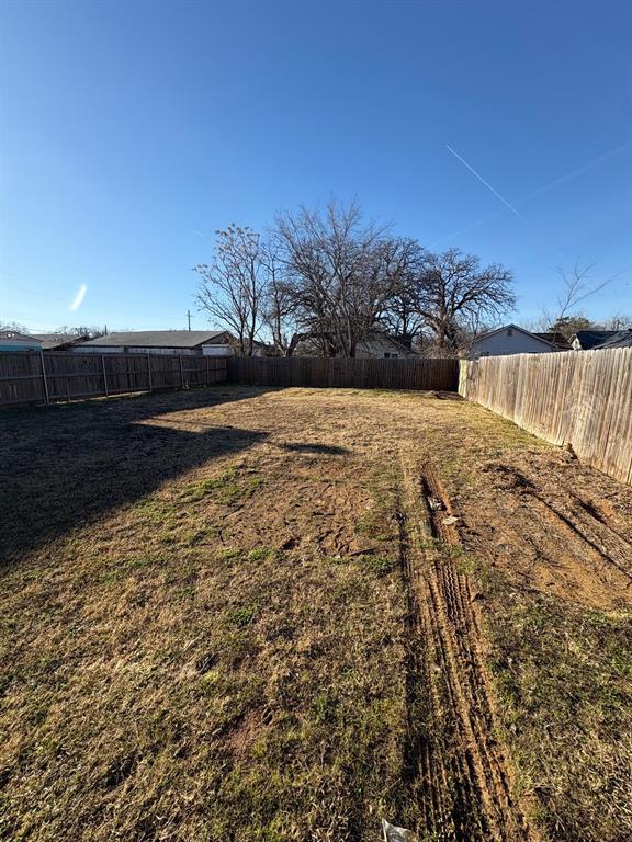 Backyard with wood fence.