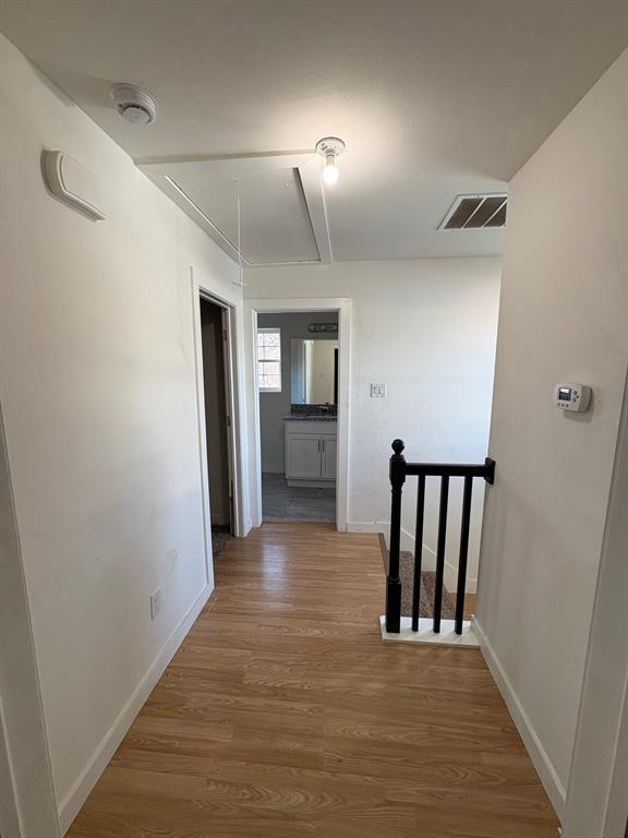 Upstairs landing. Disappearing stairs open to attic.