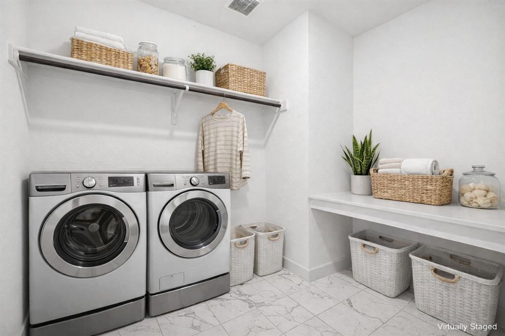 2nd floor Laundry area with separate washer and dryer and light marble finish flooring