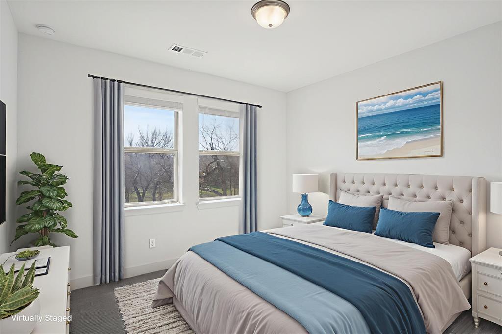 2nd floor bedroom with baseboards and dark colored carpet