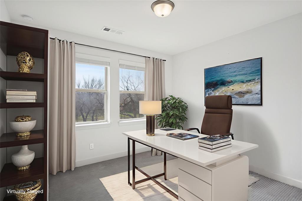 2nd floor bedroom or office area featuring baseboards and light colored carpet