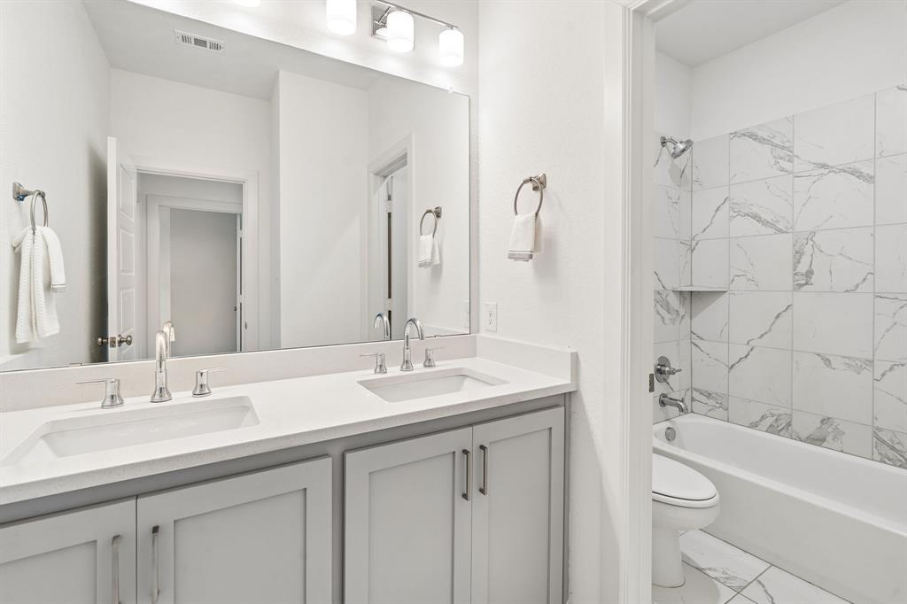 2nd floor bathroom with dual sinks and separate shower area