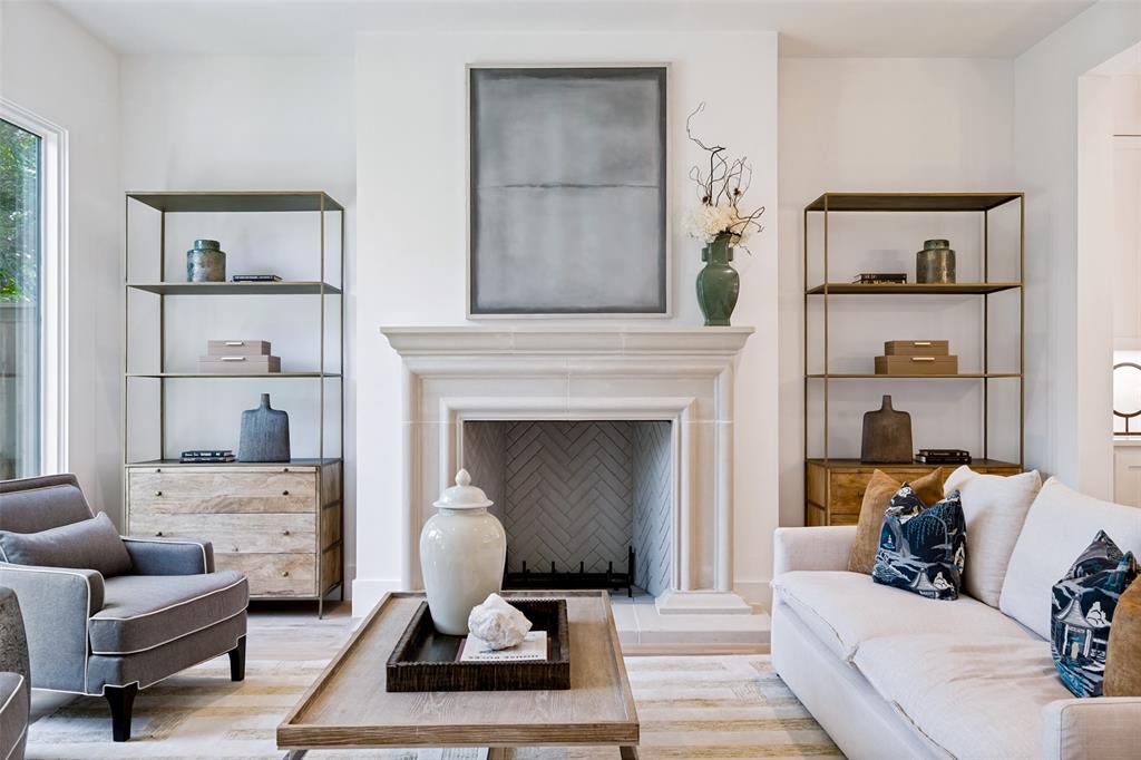 Warm Den is centered around a custom gas fireplace with cast stone mantle & surround.