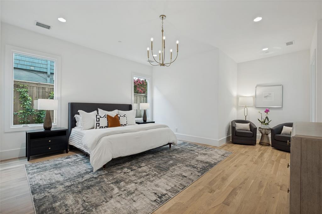 Generous sized Downstairs primary suite with seating area, spa inspired bath, oversized shower and large closet