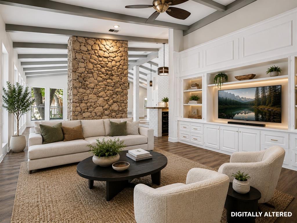 Living area featuring a stone accent wall, wood-finish flooring, and exposed ceiling beams - Virtual Staging