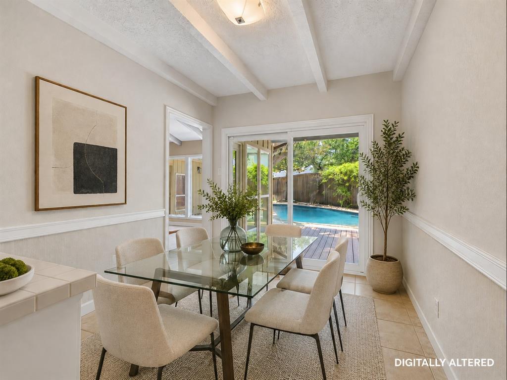 Dining area with exposed ceiling beams and crown molding