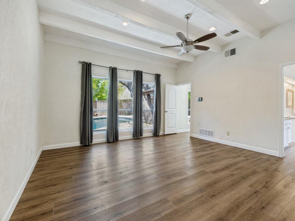 Primary Bedroom room featuring a ceiling fan, dark wood-style flooring, recessed lighting, a textured wall, and beam ceiling