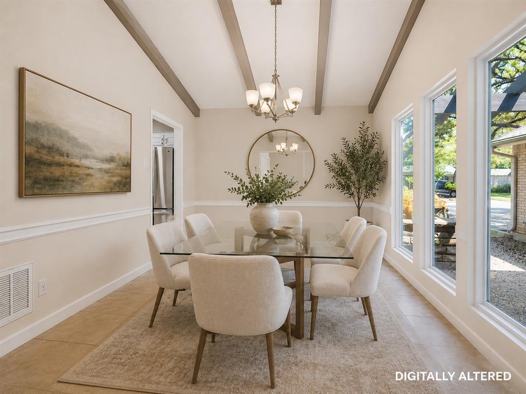 Vaulted ceiling with exposed beams and central chandelier