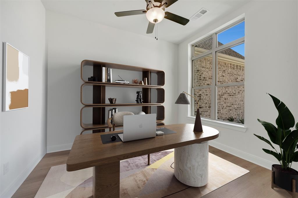 Spacious room featuring wood-finish flooring and a contemporary ceiling fan