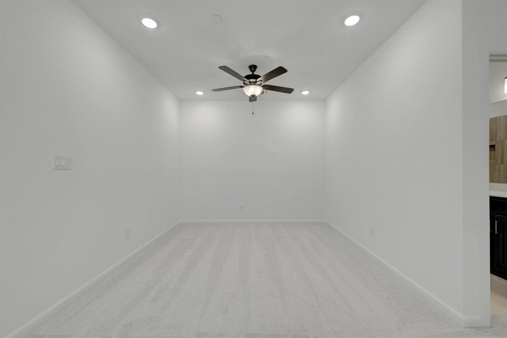 Carpeted room featuring a ceiling fan with integrated lighting and recessed lighting fixtures