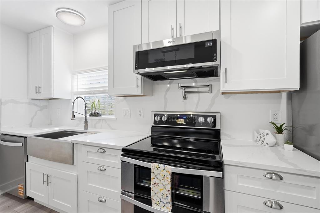 Sleek stainless steel appliances complete the modern kitchen.