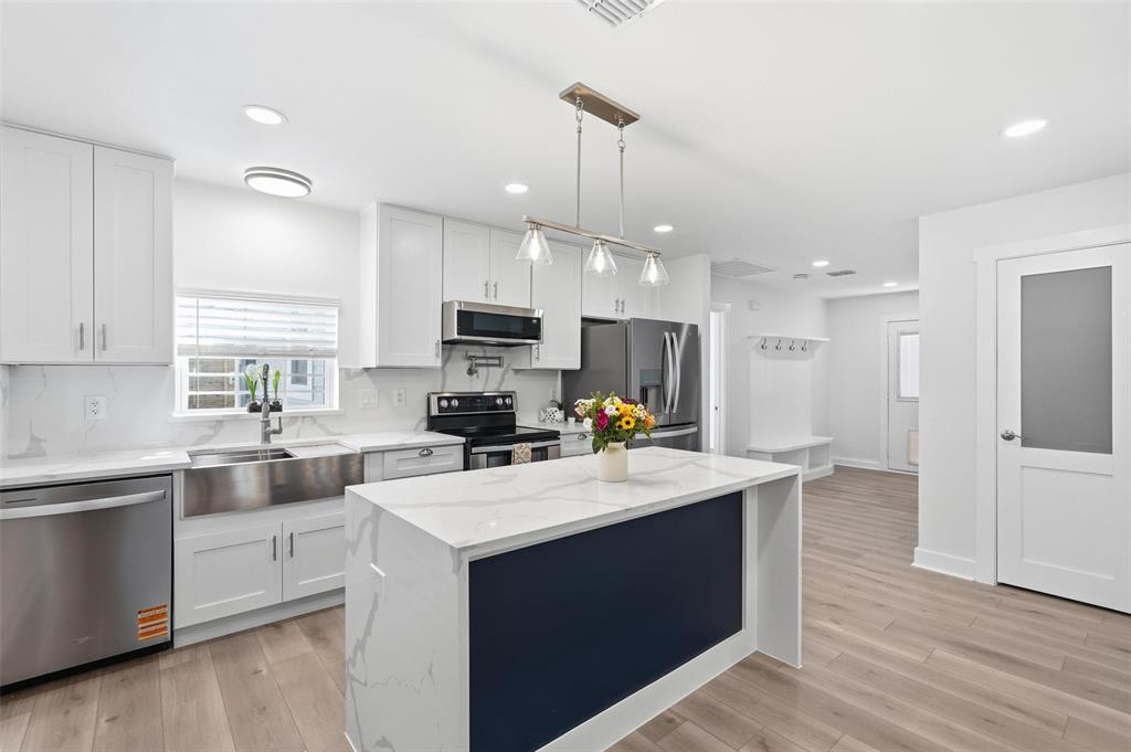 Gourmet kitchen featuring a large island and stunning quartz countertops, perfect for cooking and entertaining.