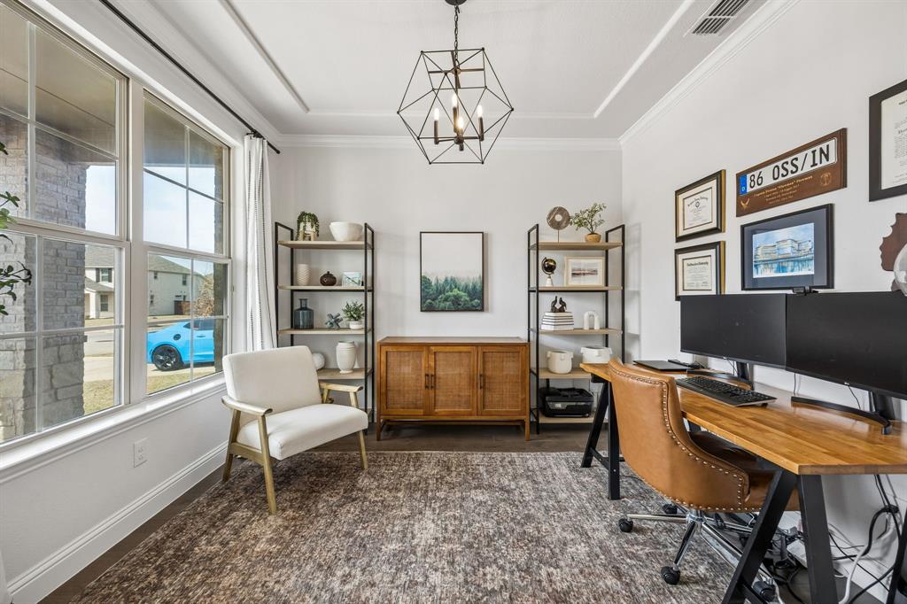 Home office featuring hanging lights and baseboards