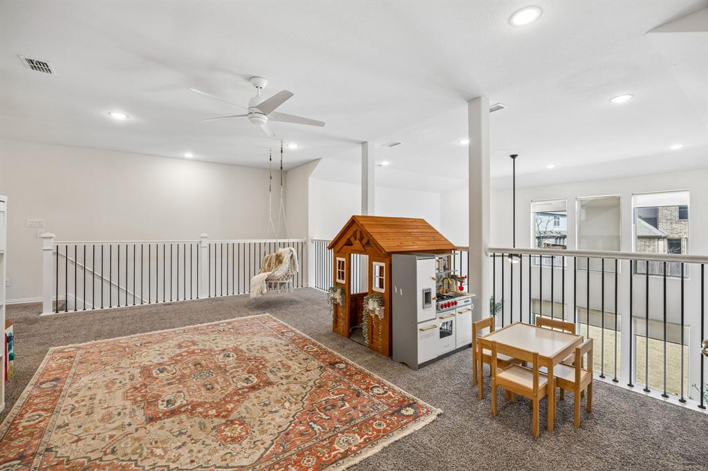 Rec room with dark colored carpet, a ceiling fan, and recessed lighting
