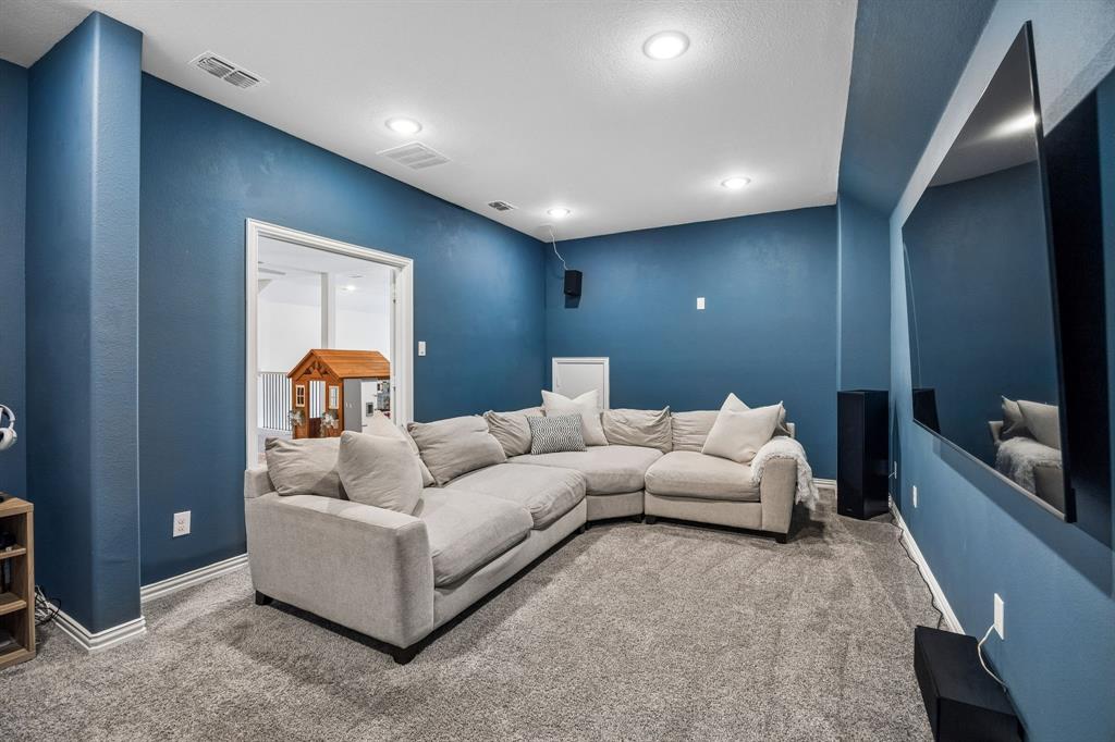 Carpeted living room featuring baseboards and recessed lighting