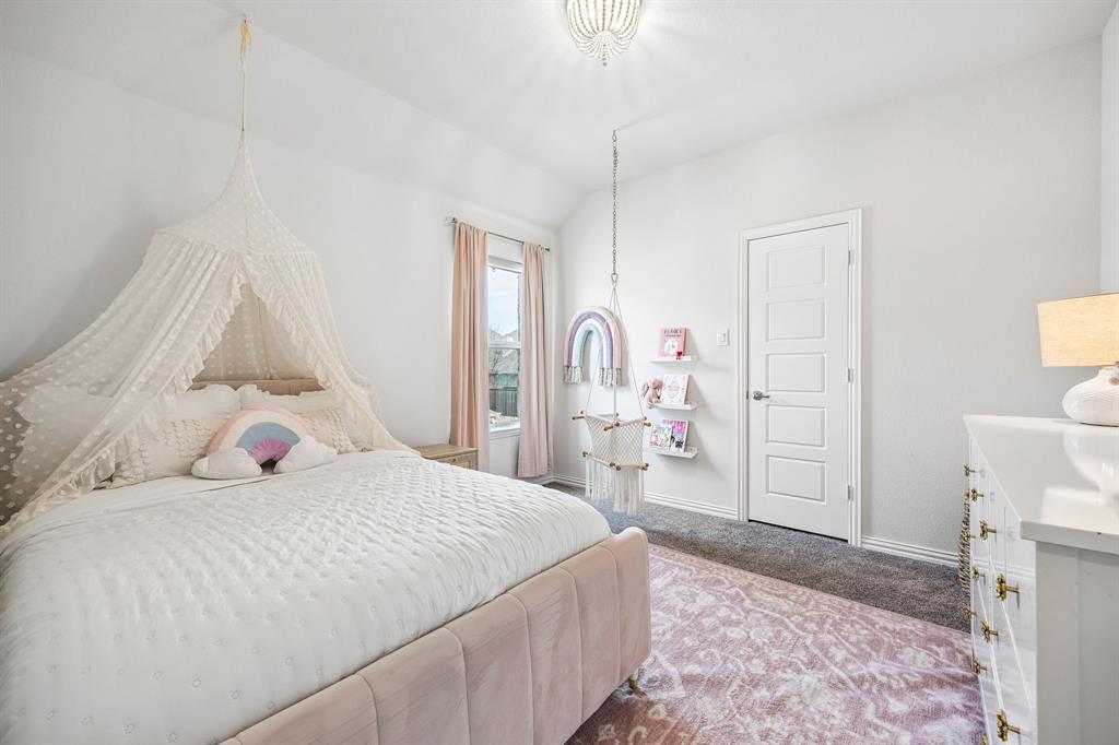 Carpeted bedroom featuring baseboards and lofted ceiling
