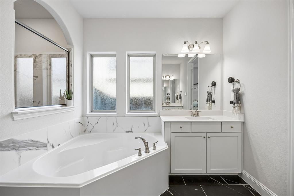 Bathroom with a bath and vanity