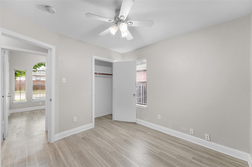 Unfurnished bedroom featuring light wood-style flooring, a ceiling fan, and a closet