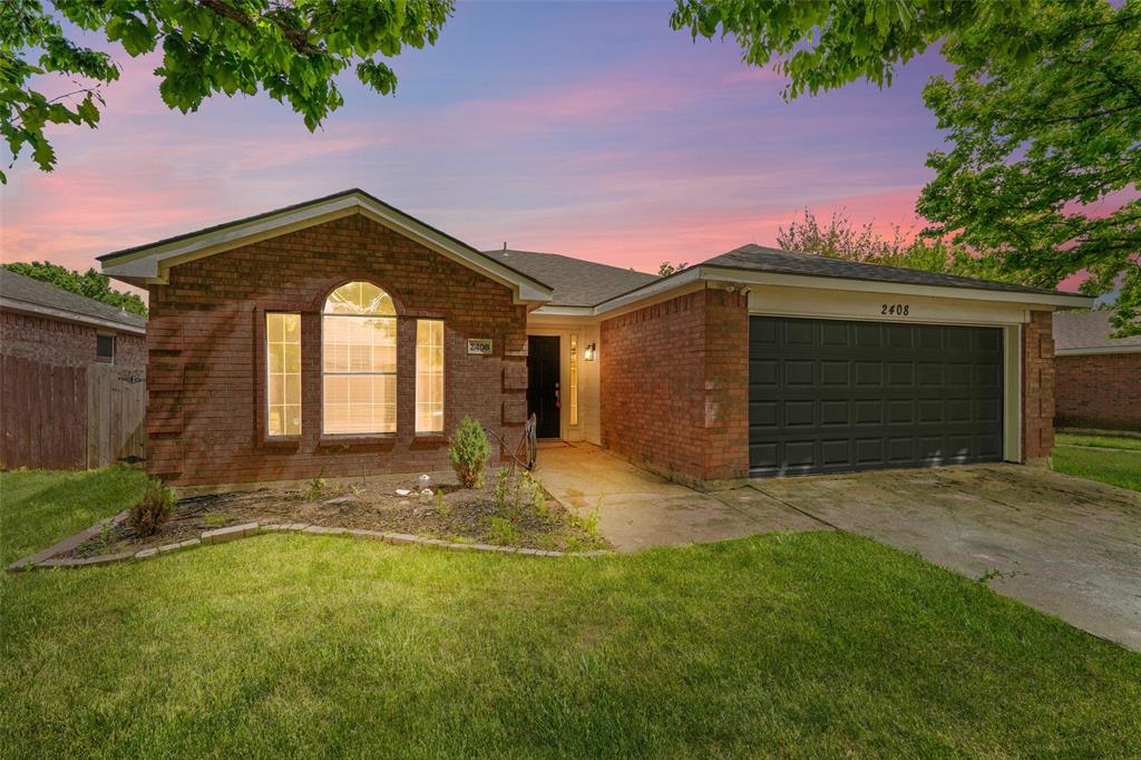 Ranch-style house with an attached garage, brick siding, and driveway