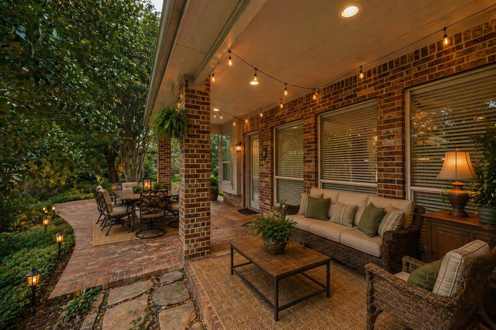 Covered patio featuring a brick exterior and recessed lighting