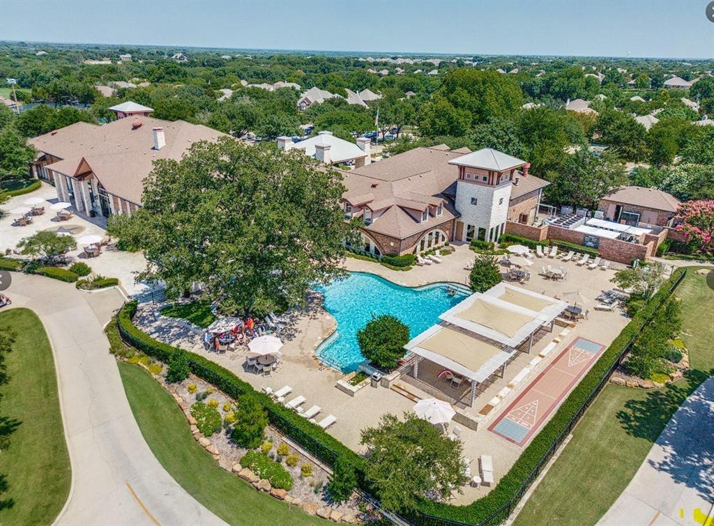 Large community pool with surrounding lounge areas, expansive clubhouse