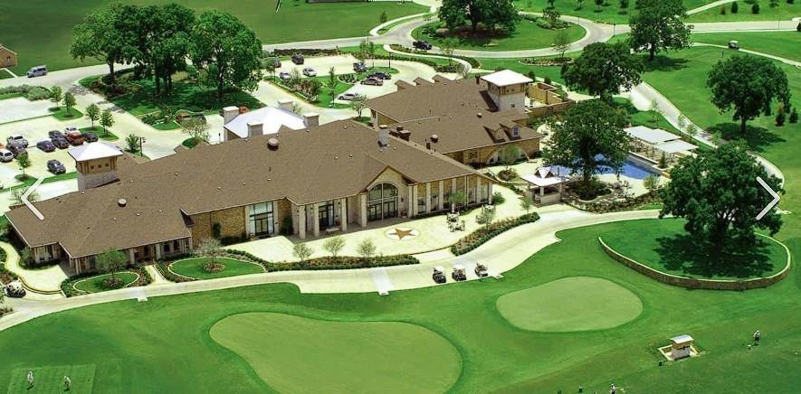 Expansive golf course setting featuring manicured greens, a clubhouse with multiple wings, a central courtyard, and an outdoor pool area