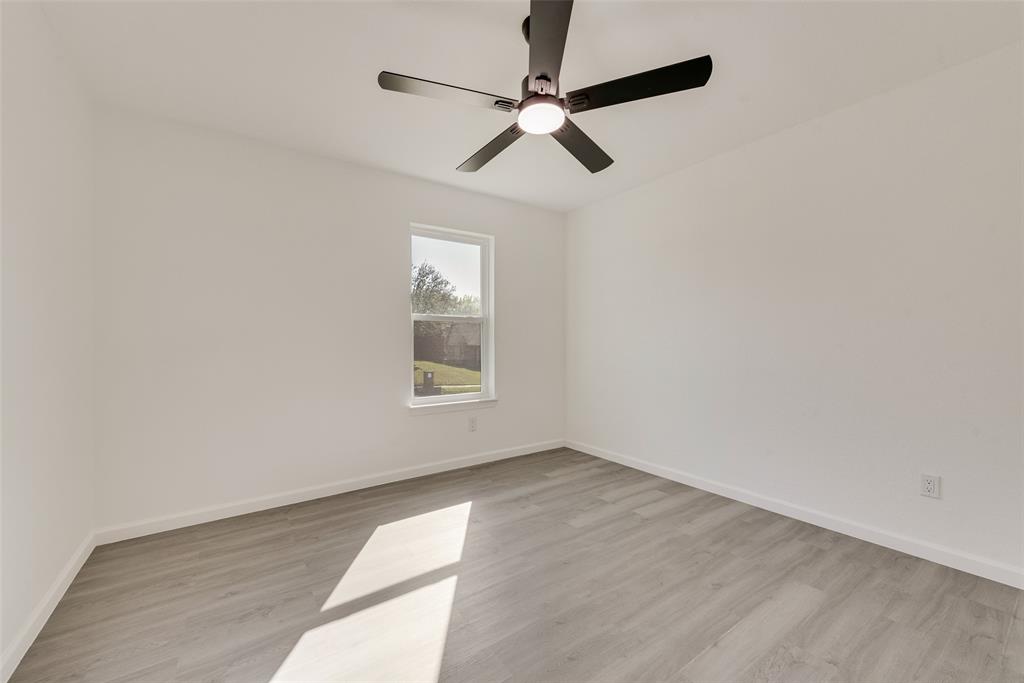 Spare room featuring light wood-style floors and a ceiling fan
