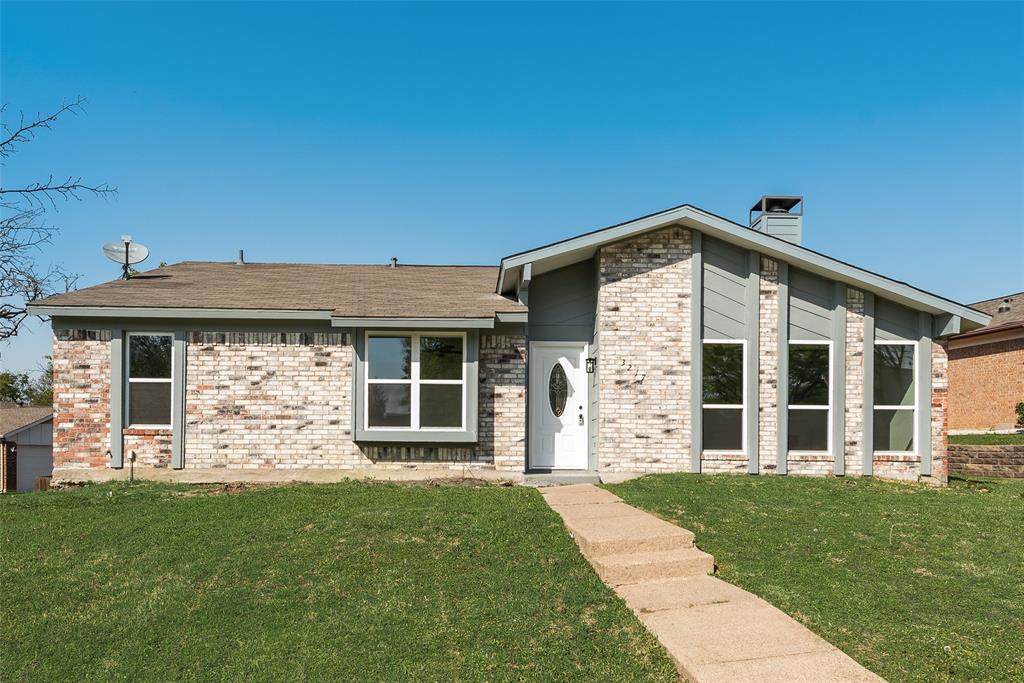 View of front of property featuring a chimney, a front yard, and brick siding View of front of property featuring a chimney, a front yard, and brick siding