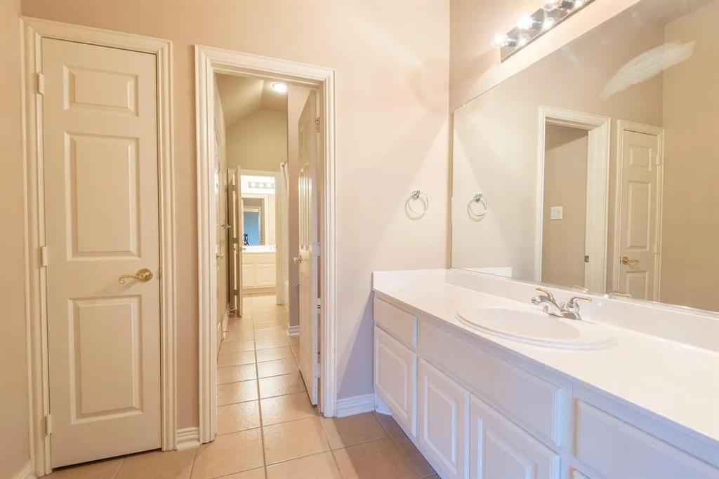 White vanity with integrated sink and chrome faucet