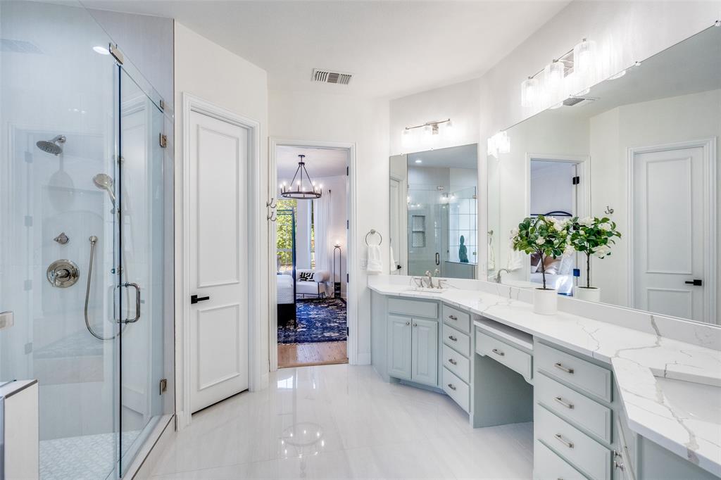 Glass enclosure shower with bench.