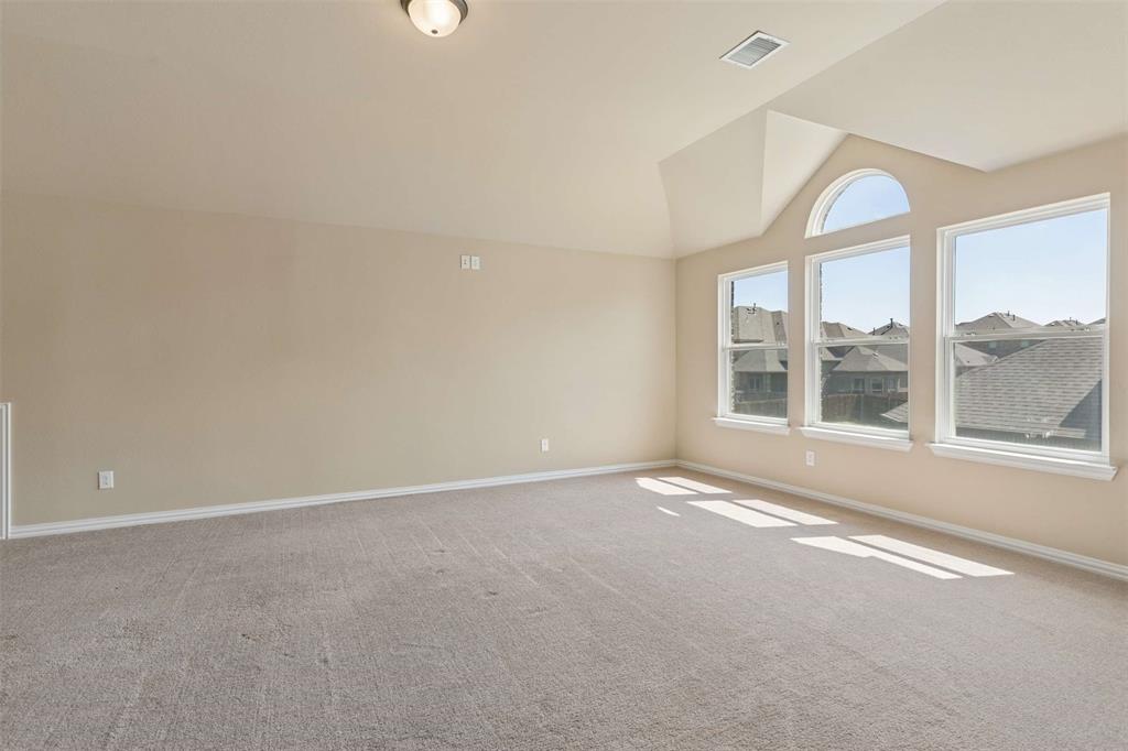 Spare room with lofted ceiling and light carpet