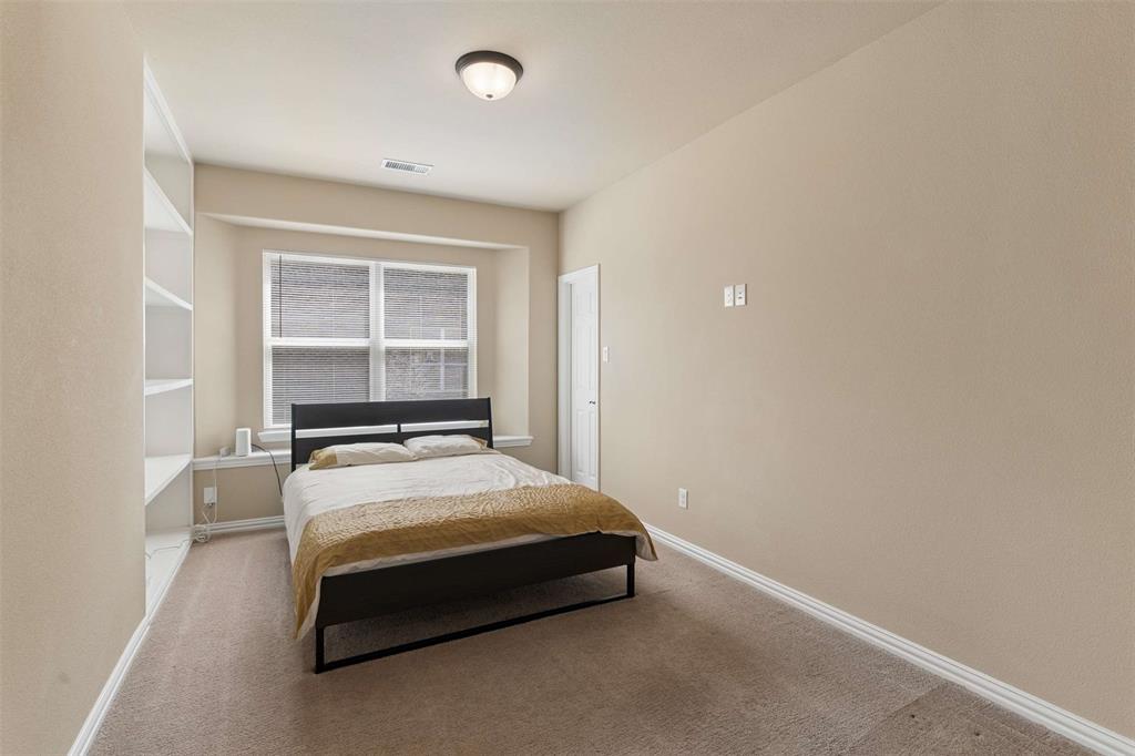 Bedroom featuring light colored carpet and baseboards