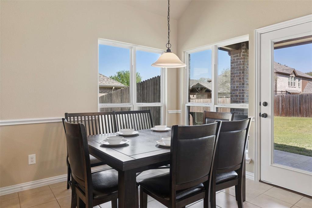 Dining space featuring vaulted ceiling and light tile patterned flooring