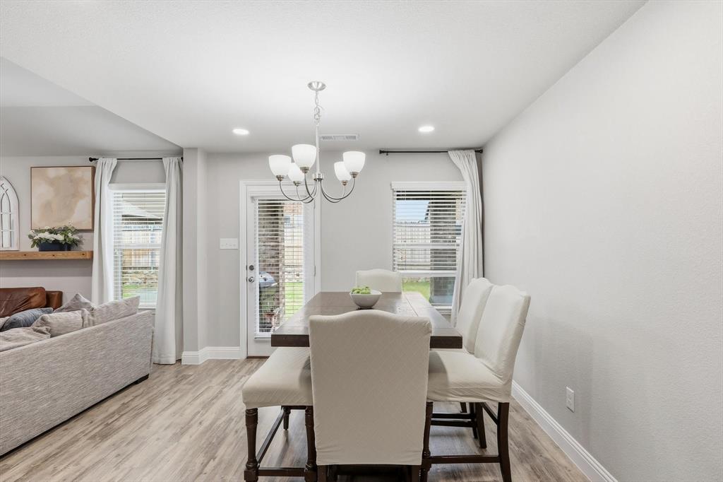 Dining area featuring wood-finish flooring and recessed lighting
