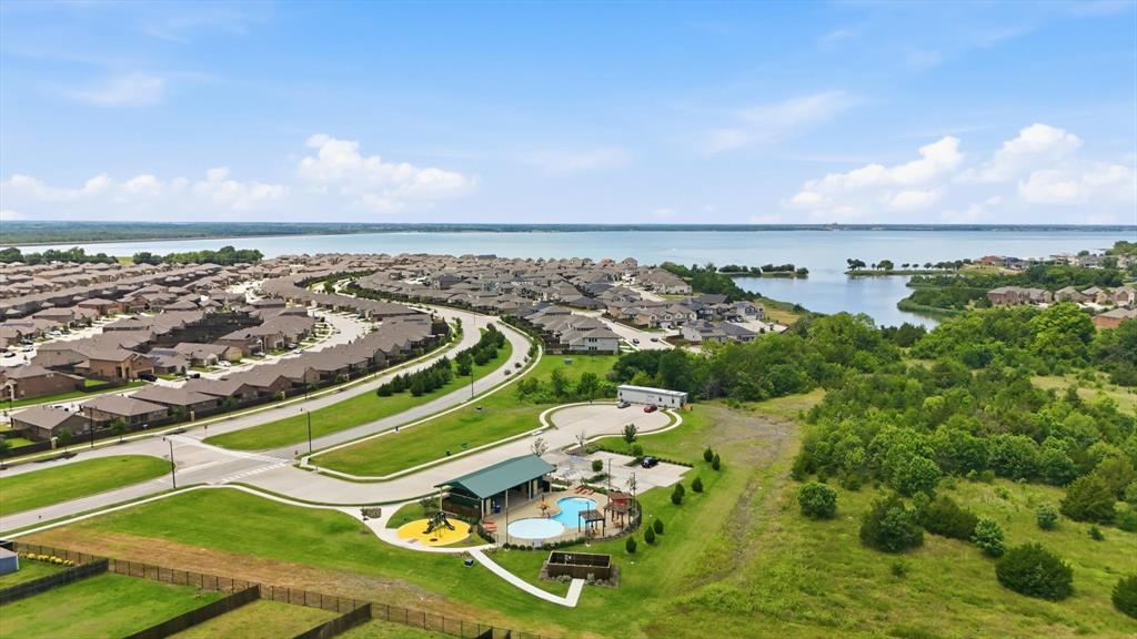 Pool #2, brand new, with playground and shallow end for kids. Just steps from beautiful Lake Ray Hubbard fishing access. Future plans include a walking path down to the water.