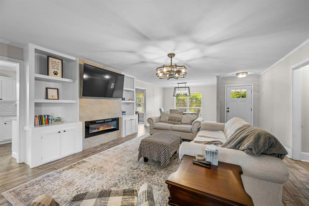 Living room featuring beautiful built ins and an electric fireplace Living room featuring beautiful built ins and an electric fireplace