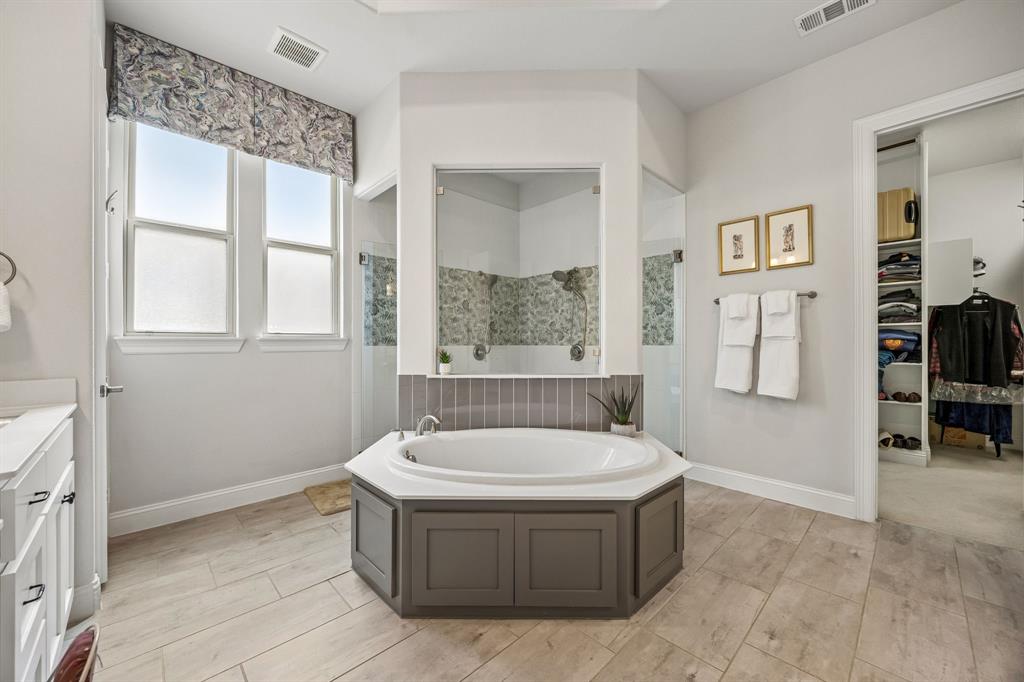 The spa like bath flows straight into the massive walk in closet which tansitions seamlessly into the first floor dedicated laundry and utility space.