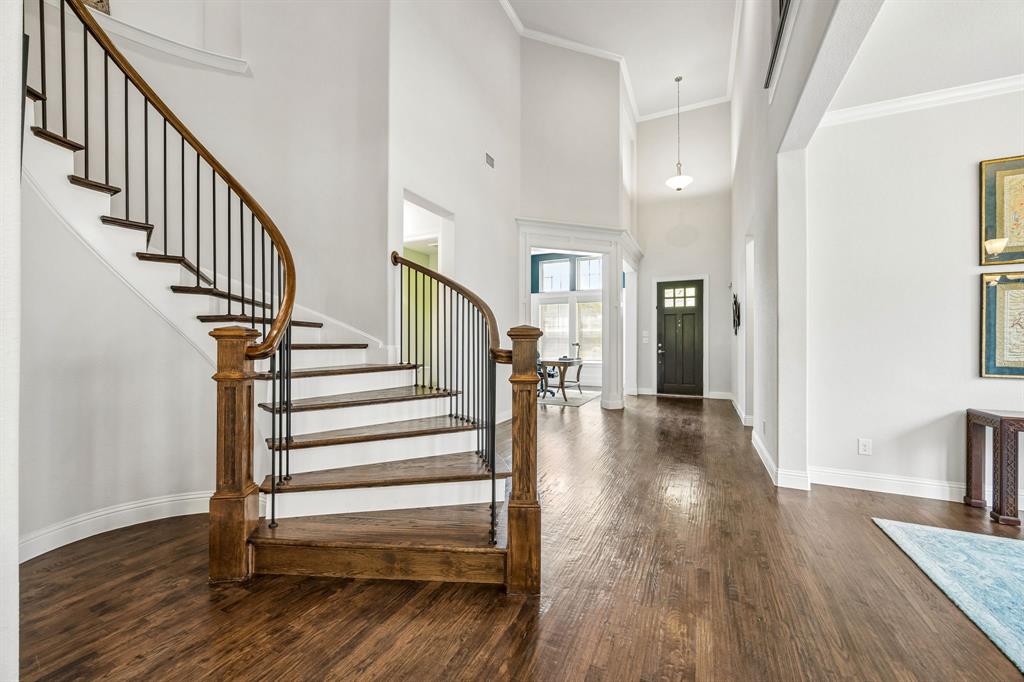 High soaring ceilings create an immediate sense of scale, airiness, and sophisticated luxury. The flowing curved staircase featuring wood treads and crisp white risers creat a dramatic focal point in the home. High soaring ceilings create an immediate sense of scale, airiness, and sophisticated luxury. The flowing curved staircase featuring wood treads and crisp white risers creat a dramatic focal point in the home.