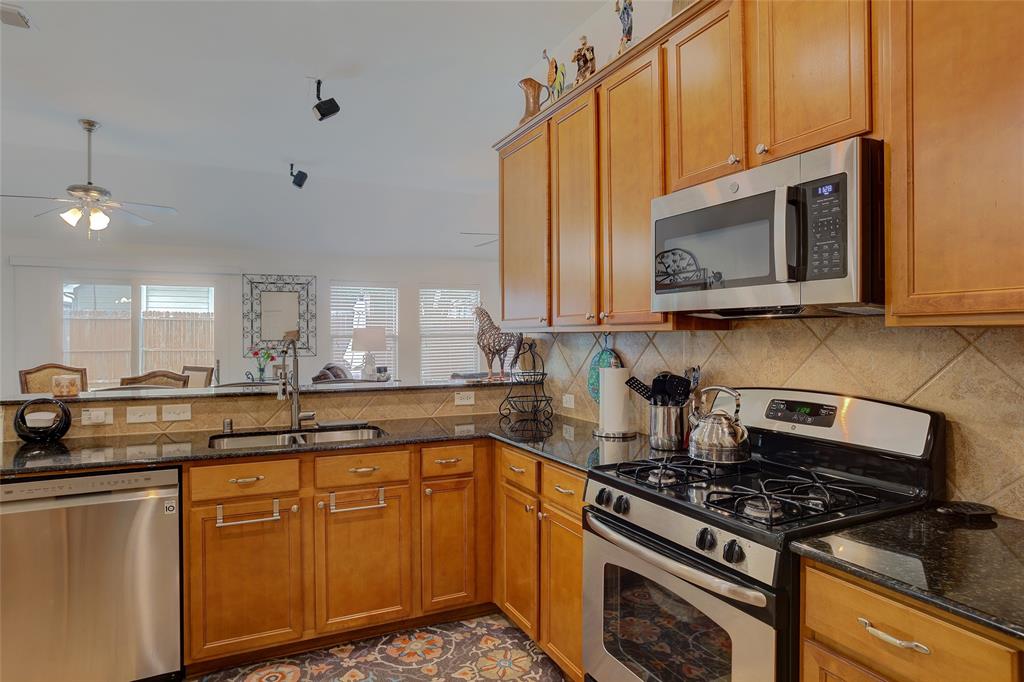 Open Kitchen with access and views of Living Room and Backyard