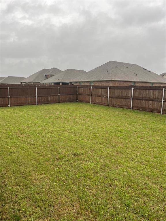 View of fenced backyard