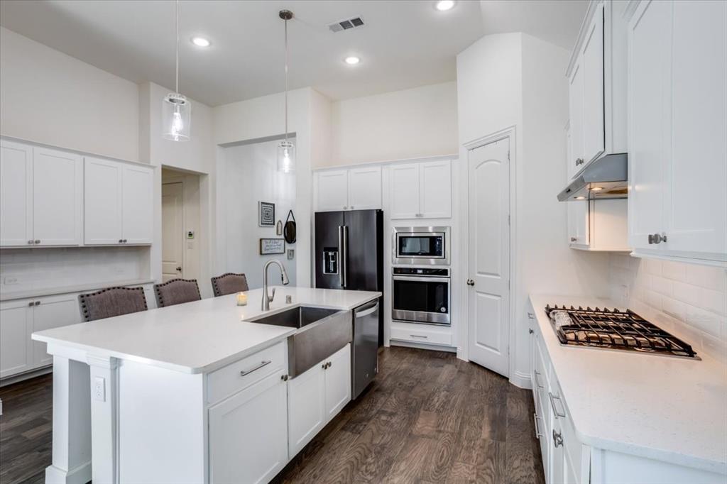 An abundance of storage with clean, classic countertops with square edge.