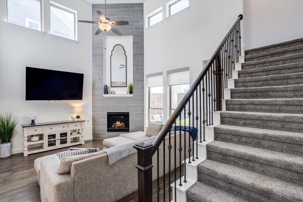 Carpeted staircase with iron spindles.