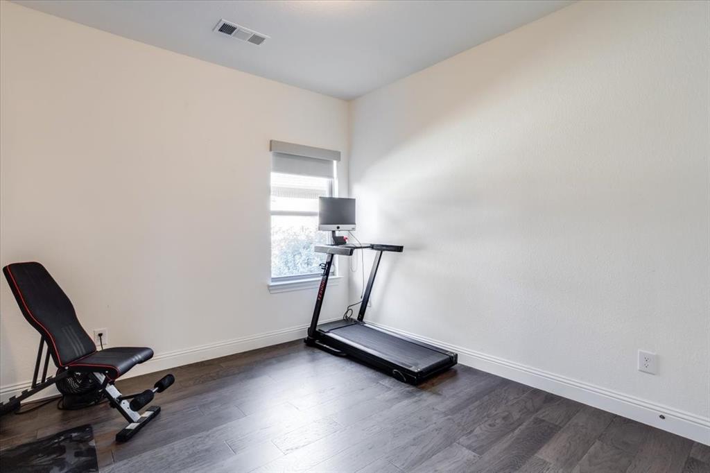 Secondary bedroom currently being used as a home gym.