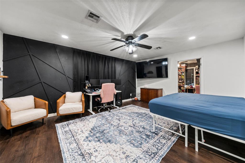 Bedroom with a desk, ceiling fan, dark wood-type flooring, and recessed lighting