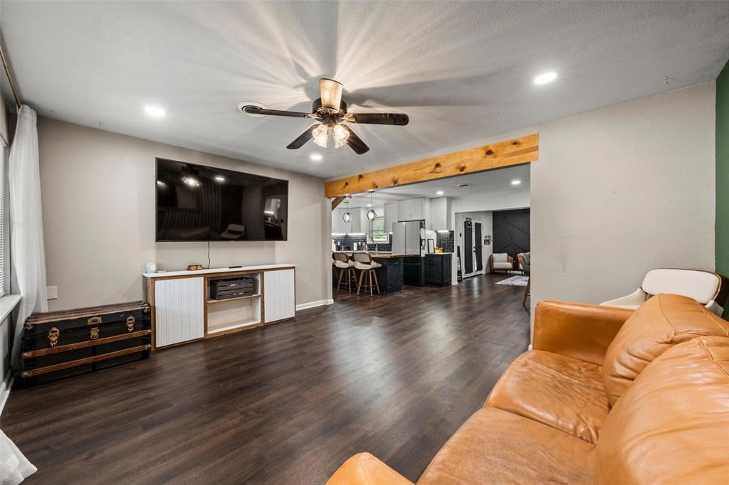 Living area with recessed lighting, dark wood-style floors, ceiling fan, and beam ceiling Living area with recessed lighting, dark wood-style floors, ceiling fan, and beam ceiling