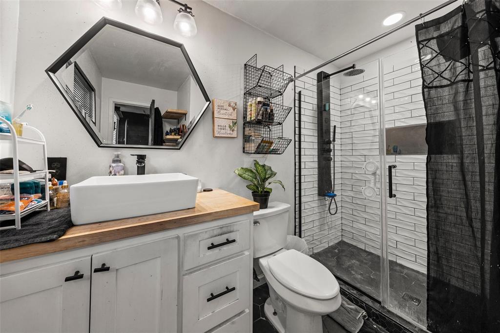 Full bathroom with vanity and a shower stall