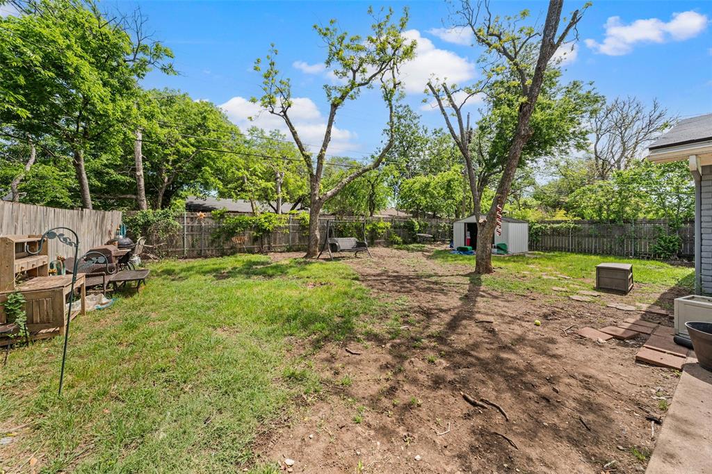 Fenced backyard with a shed