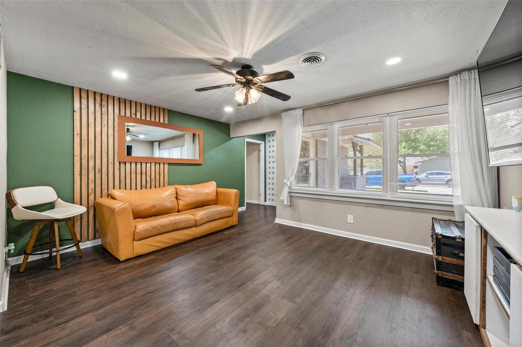 Living area with dark wood-type flooring, ceiling fan, recessed lighting, and a textured ceiling Living area with dark wood-type flooring, ceiling fan, recessed lighting, and a textured ceiling