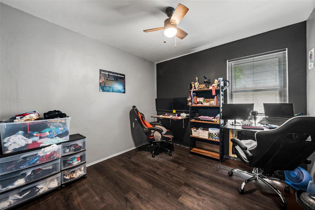 Office space featuring dark wood-style flooring and ceiling fan